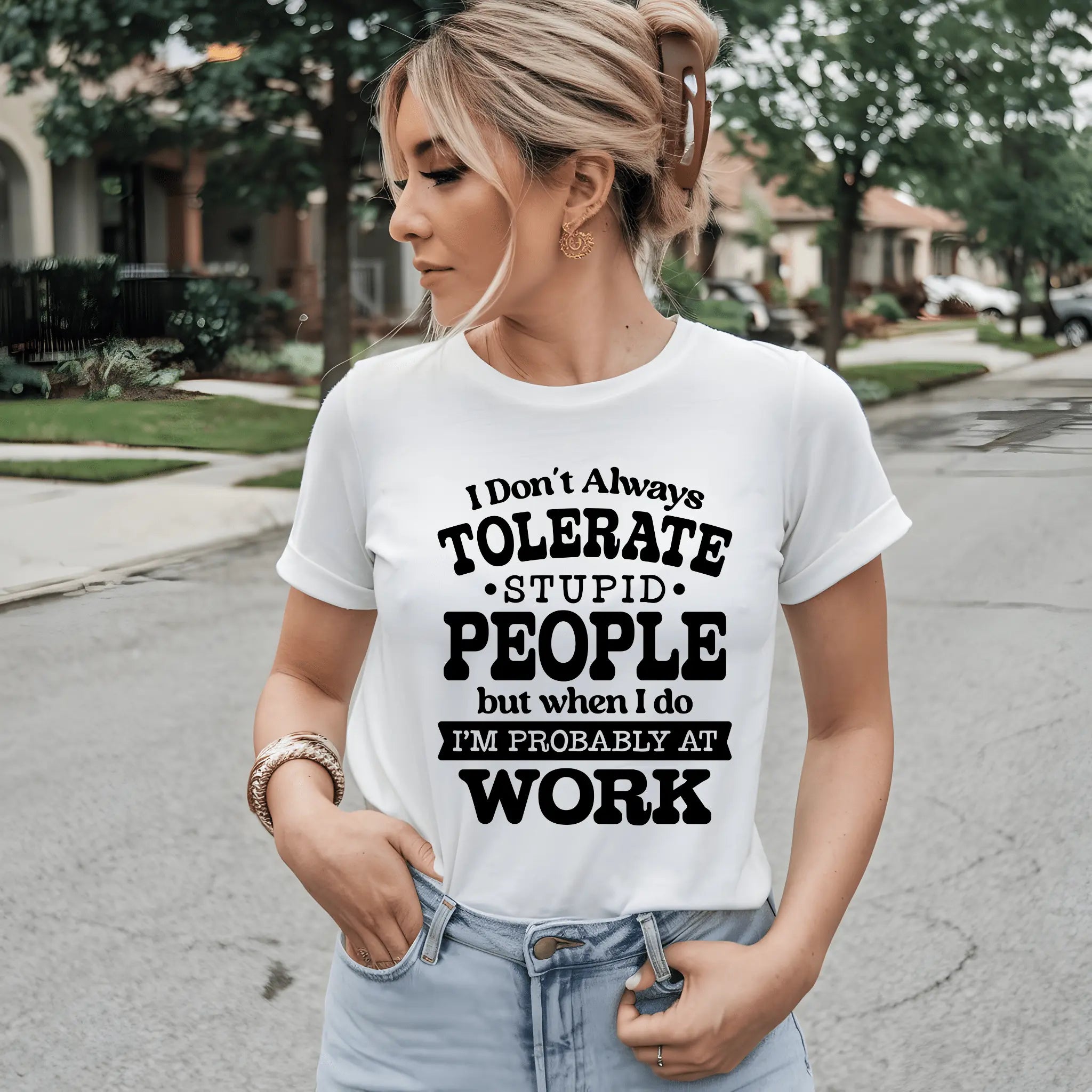 Frau mit weißem Statement-T-Shirt auf der Straße, lässig mit Händen in der Jeans.